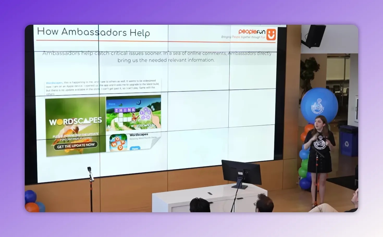WordscapesCon presentation with slide 'How Ambassadors Help' and presenter on stage